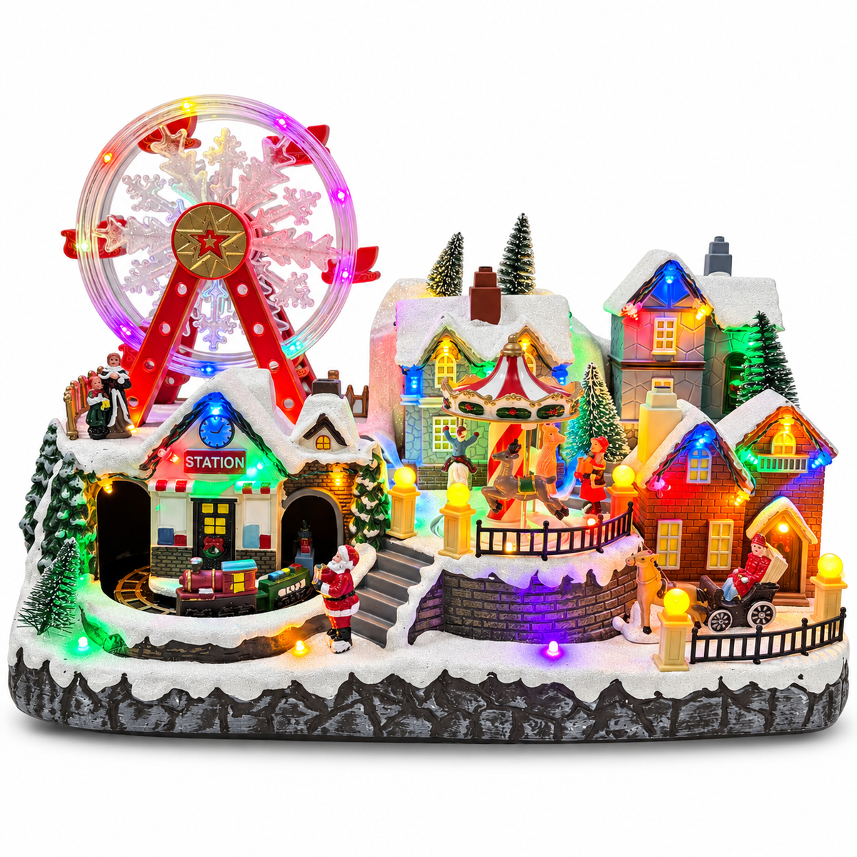 Musical Christmas village with lighted Ferris wheel, carousel, train station and snowy houses on a white background