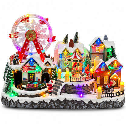 Musical Christmas village with lighted Ferris wheel, carousel, train station and snowy houses on a white background