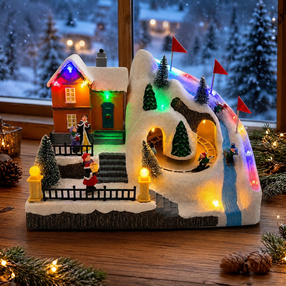 Animated Christmas village ski slope with moving figures, snowy house and colorful LED lights