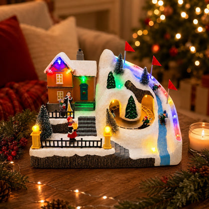 Christmas ski village tabletop decoration with snow-covered mountain track and red course flags