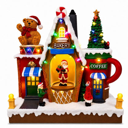 Lighted and unlighted comparison of musical Christmas village bakery decoration with rotating Santa
