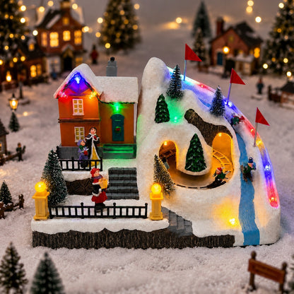 Christmas ski village tabletop decoration with snow-covered mountain track and red course flags