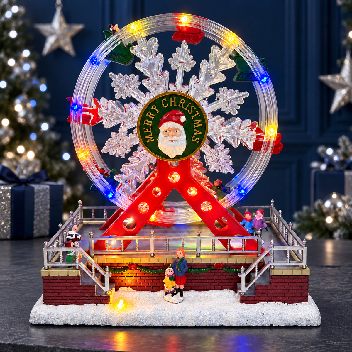 Lighted Santa snowflake Ferris wheel displayed on a console against a navy blue Christmas backdrop