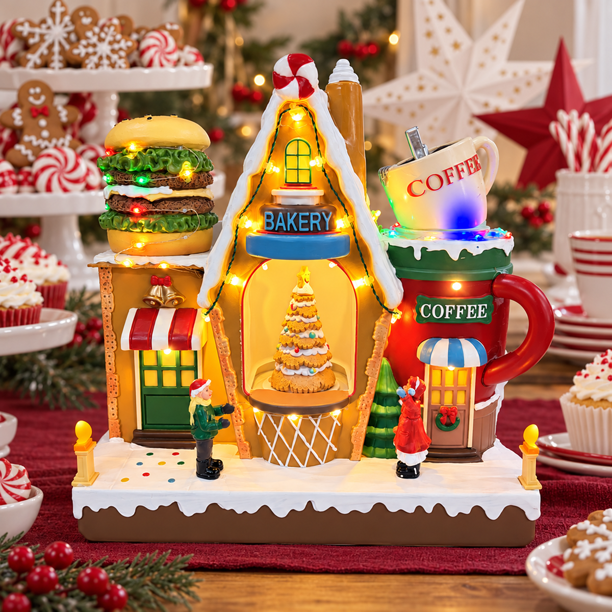Lighted Christmas bakery and coffee shop on a holiday dining table with burgundy linens and festive place settings